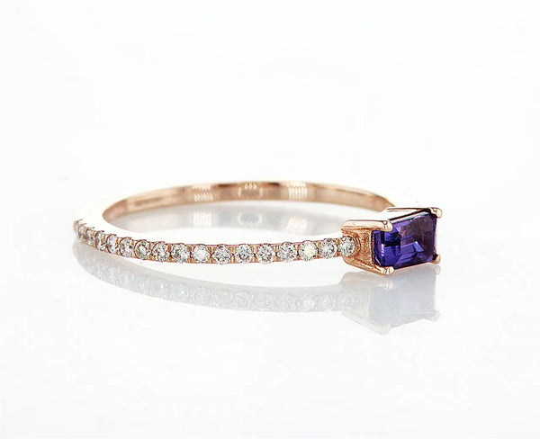 Purple sideway emerald cut sapphire with a pavé band