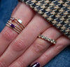 Purple sideway emerald cut sapphire with a pavé band